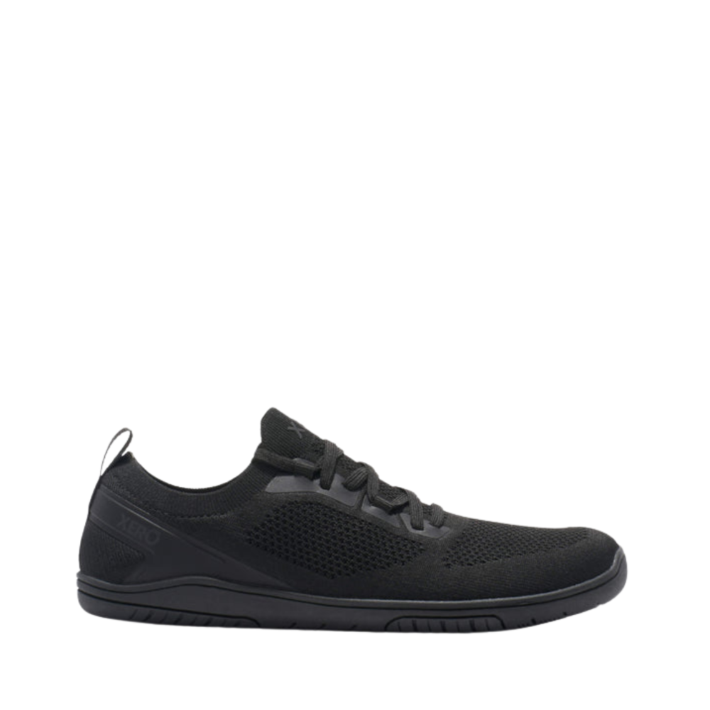 Side view of the black Xero Nexus shoe with a knit upper and thin sole.