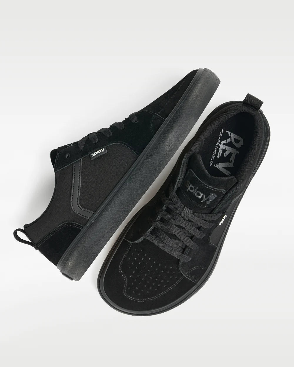 Low-profile black sneakers viewed from above, with laces and perforated toes.