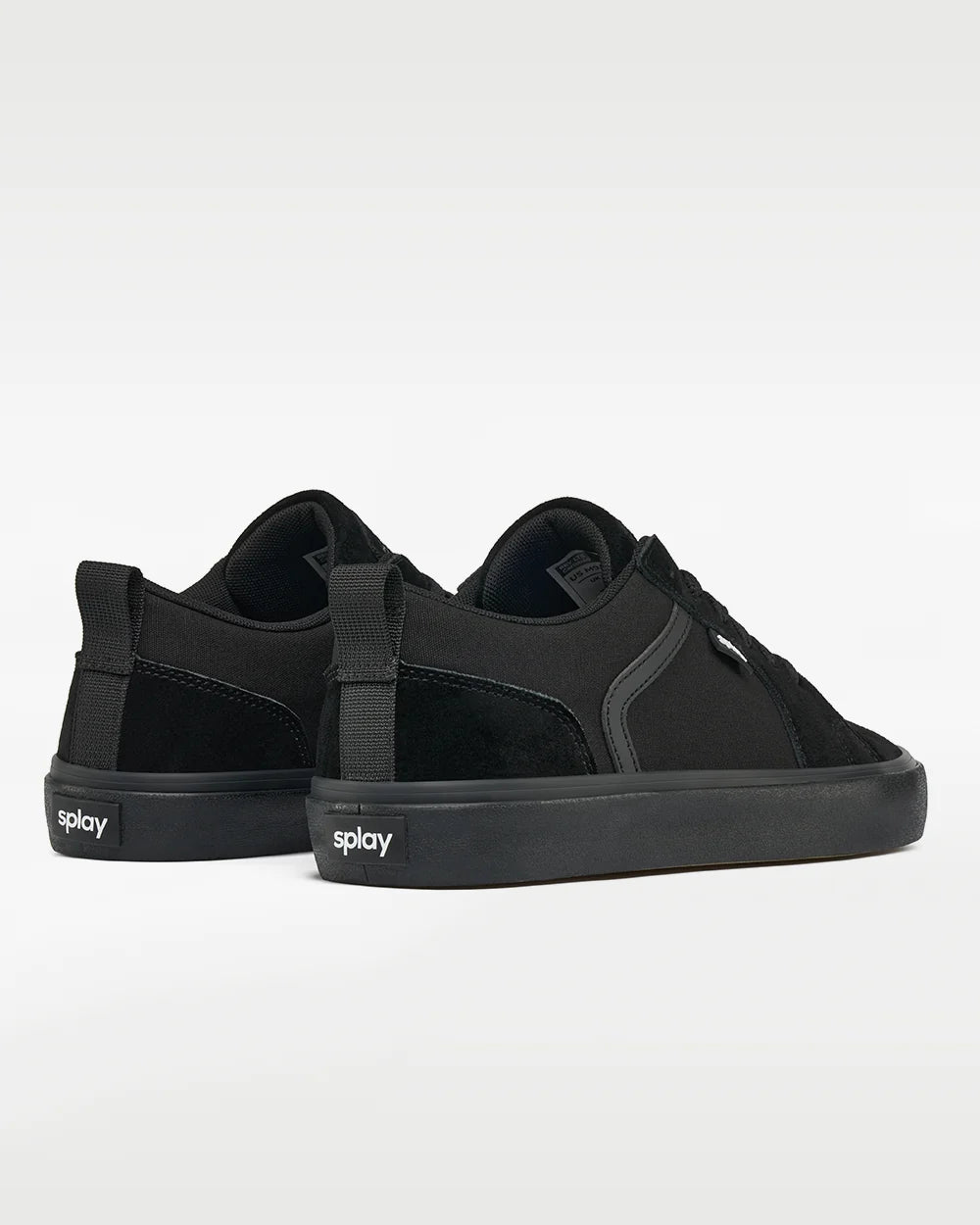 Pair of low-profile black sneakers viewed from behind, with pull tabs and Splay logo.