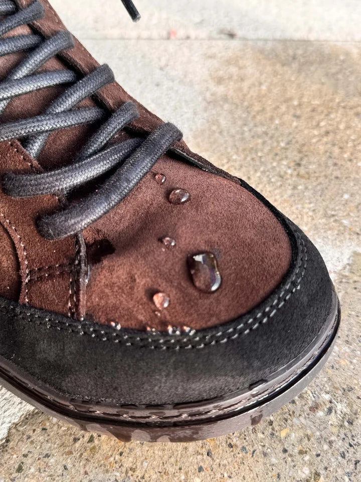 Detail of the brown suede vamp with water droplets and dark laces.