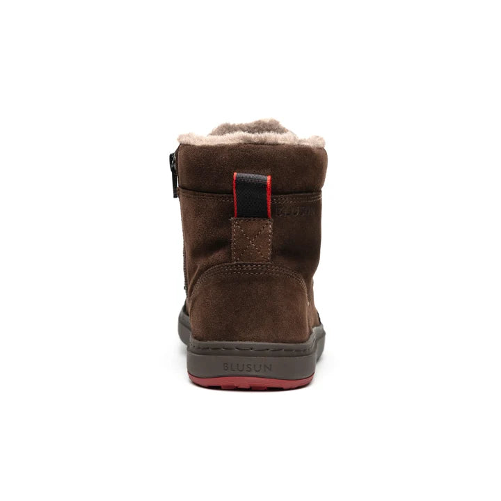 Rear view of the brown ankle boot, with a red strap and gray sole.
